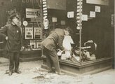 Egy betört kirakatú üzletet őriz két rendőr a Warren Streeten a robbanást követően (kép forrása: sobrehistoria.com)