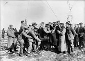 Német katonák segítenek egy ballonos megfigyelőnek levetni nehéz ruháit, 1915.